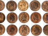 a close up of a bunch of coins on a white surface