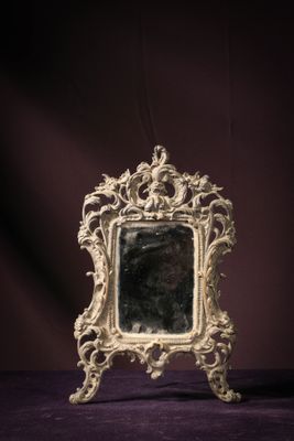 a mirror that is sitting on a purple surface