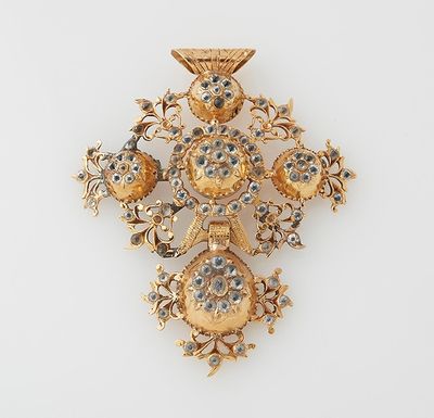 an image of a gold and diamond cross broochle