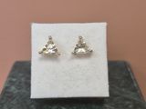 a pair of earrings sitting on top of a marble block
