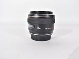 a camera lens sitting on a white surface