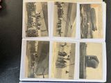 an old photo of a bunch of old photos on a table