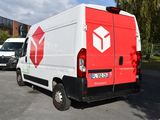 a red and white delivery truck parked in a parking lot