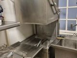 a stainless steel sink in a kitchen with a window