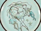 a blue plate with a drawing of a horse and a bird on it