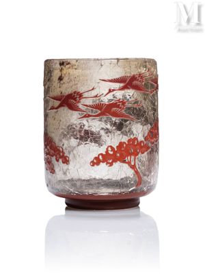a glass cup with a red dragon design on it