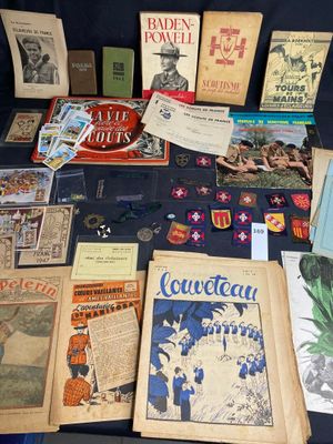 many books and pamphlets on a table with a blue table cloth