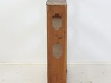 a small wooden box with holes in it on the floor