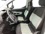 the interior of a small car with a steering wheel and seat covers