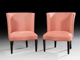 pair of pink upholstered chairs with black legs