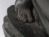 statue of a person holding a piece of wood in their hand