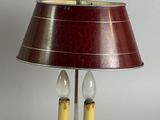 a lamp that is on a table with a red shade