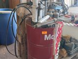 a red barrel with chains on it in a garage