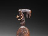 an old wooden sculpture of a horse with a rope around it ' s neck