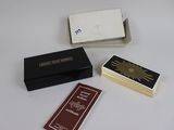three match cards are sitting on a table next to a box of matches