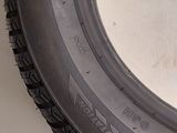 a close up of a tire on the side of a white wall