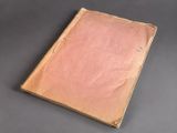 an old book sitting on top of a gray surface