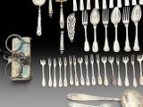 a lot of silver spoons and forks and spoons