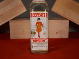 a bottle of dry gin sitting on a red table