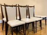 four chairs sitting in a row on a hard wood floor