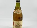 an image of a bottle of wine sitting on top of a white table
