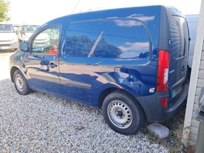 une camionnette bleue garée sur le gravier