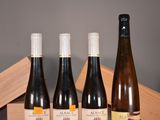 three bottles of wine are sitting on a table next to a wooden box