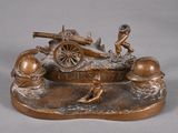 bronze statue of a man with a gun and a man on a cart