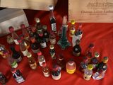many bottles of liquor on a table with a wooden box
