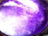 a ring with a purple stone in it sitting on a table