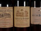 several bottles of wine are lined up on a shelf