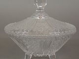 a clear glass bowl with a lid on a table