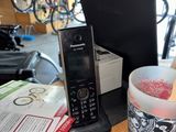 a cell phone and a cup on a table
