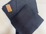 three pairs of blue jeans folded on top of each other