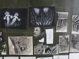 many drawings on the wall of a bathroom