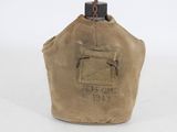 a close up of a tan canvas bag with a small bottle in it