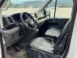 the interior of a white truck with the door open and the driver ' s seat up