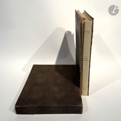 two books sitting on top of each other on a table