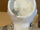 a white vase with a face on it sitting on a table