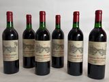 six bottles of wine are lined up on a table