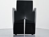 a black chair with a water spout coming out of it