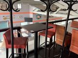 three stools sitting at a table in a restaurant