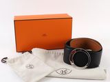 an orange box with a black belt and a white bag