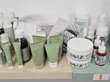 many different types of skin care products displayed on a shelf