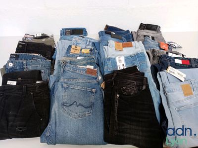 a lot of jeans stacked on top of each other