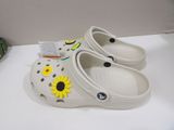 a pair of crocs that have sunflowers on them
