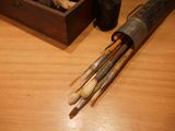 a wooden box filled with brushes and a wooden box filled with rocks
