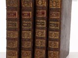 three old books sitting on top of each other on a table