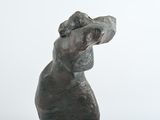 a statue of a dog that is sitting on top of a table
