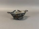 an antique silver plated bowl with a handle and handles